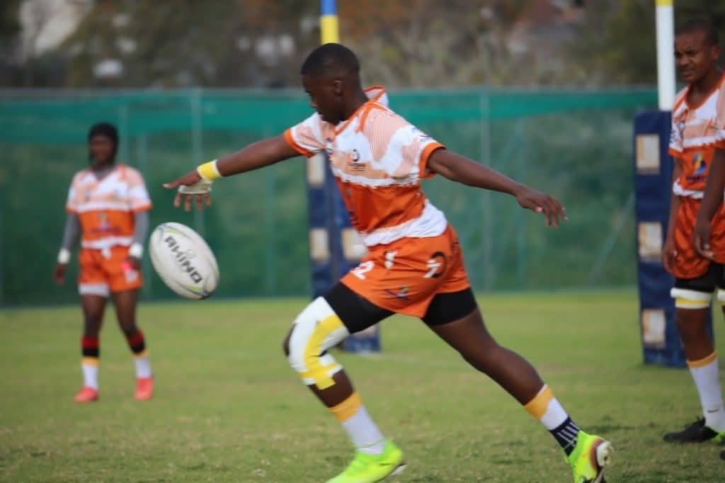 Olutsha Academy player striking a kick during a match
