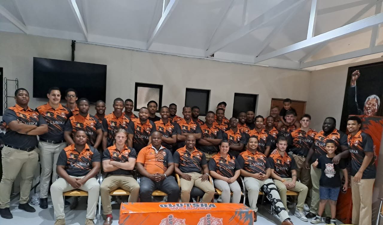 The Olutsha Wolves squad and management group together indoors