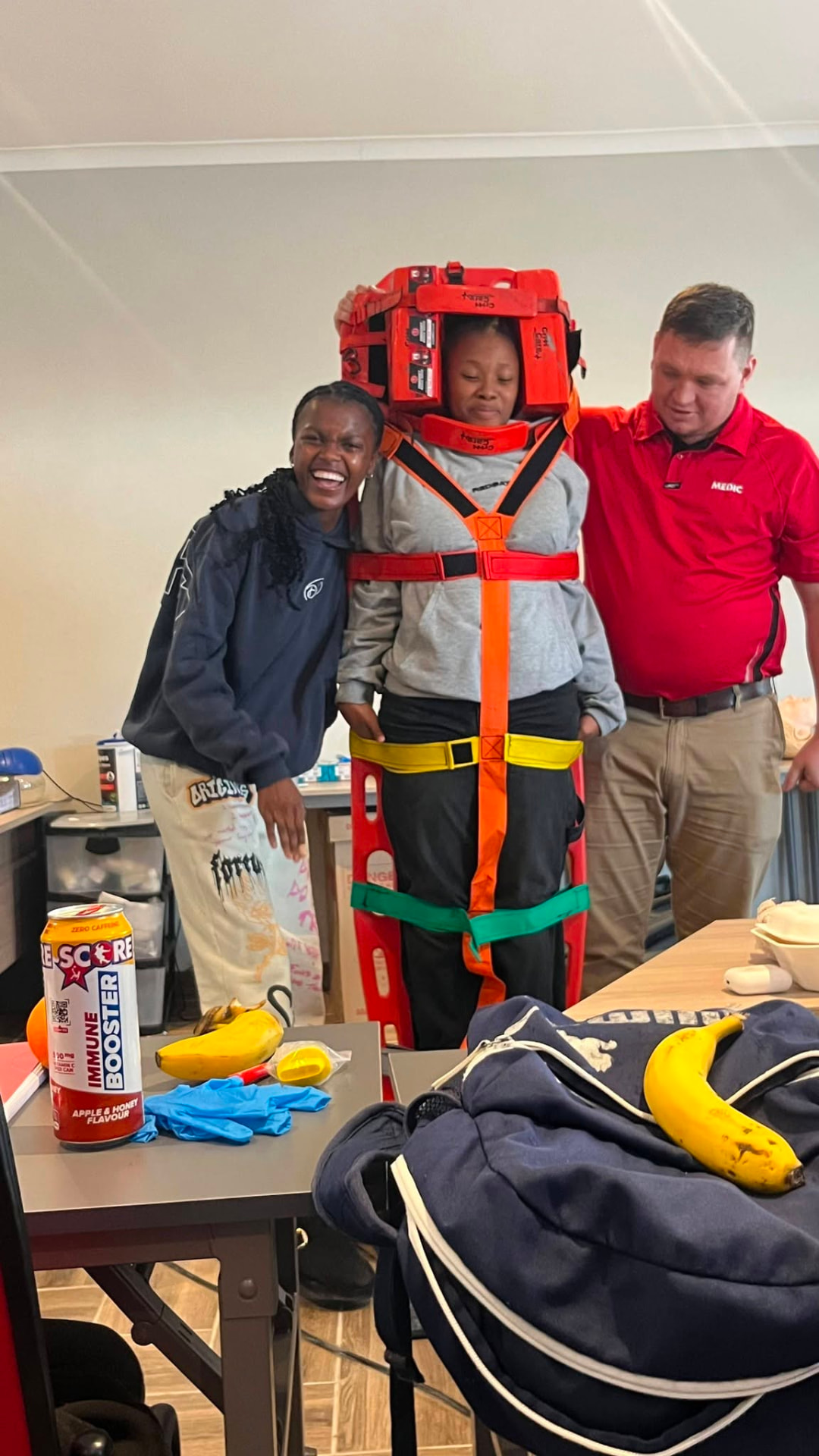 Learners demonstrating spinal immobilisation with a Red Alert instructor