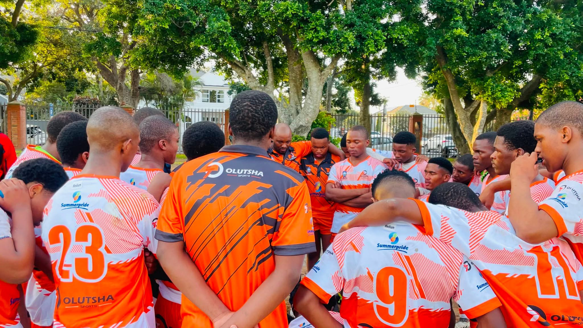 Olutsha players in a team huddle before kick-off