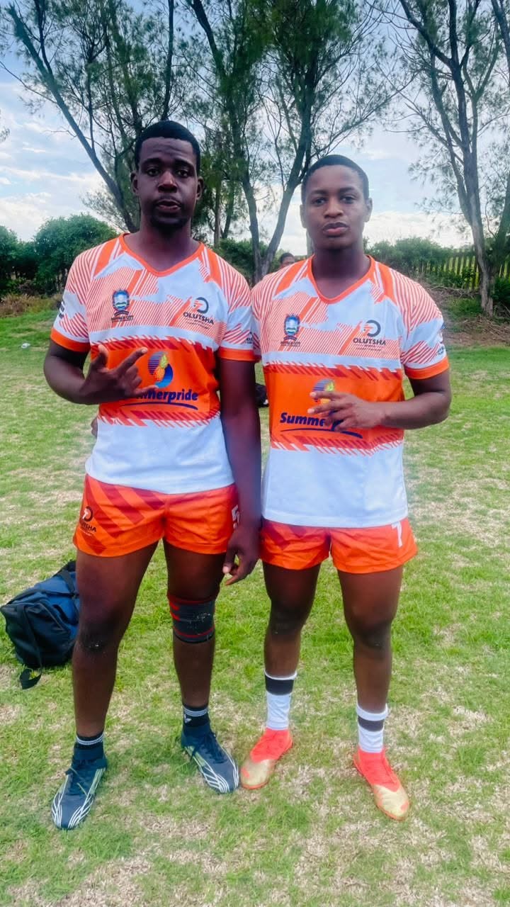 Two Olutsha Wolves players in the 2026 Summerpride home kit before kick-off