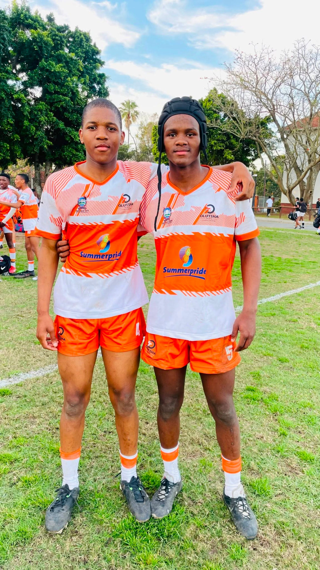 Two Academy players in Summerpride-sponsored kit after a match