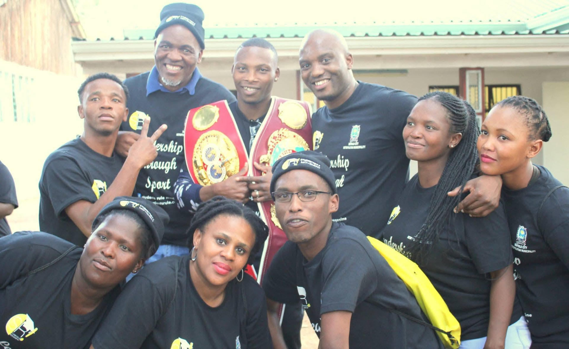 Zolani Tete with his world title belt and the Students Rule Movement team